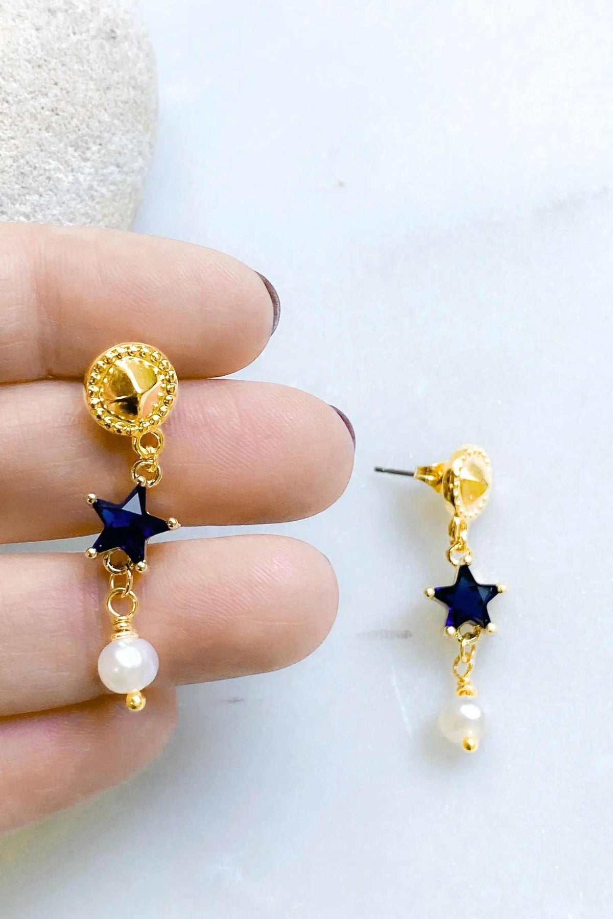 STAR dangle drop earrings with gold-tone settings, blue star stones, and white pearl drops