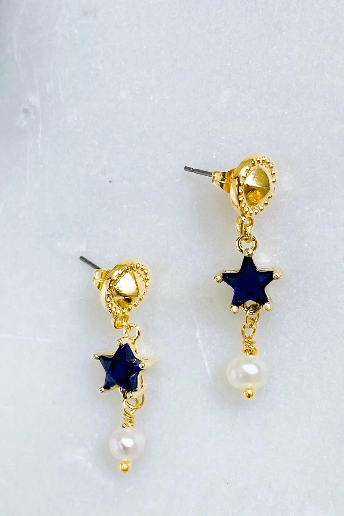 STAR dangle drop earrings in gold-tone metal with dark blue star charms and white pearl drops