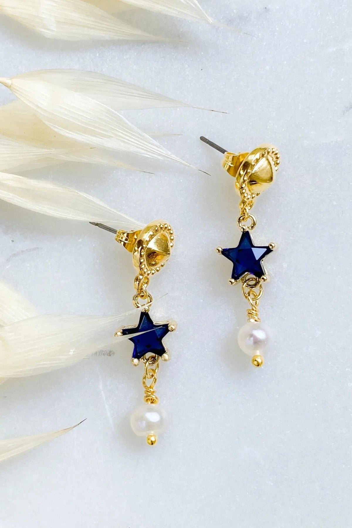 STAR dangle drop earrings in gold-plated metal with deep blue star charms and dangling white pearls