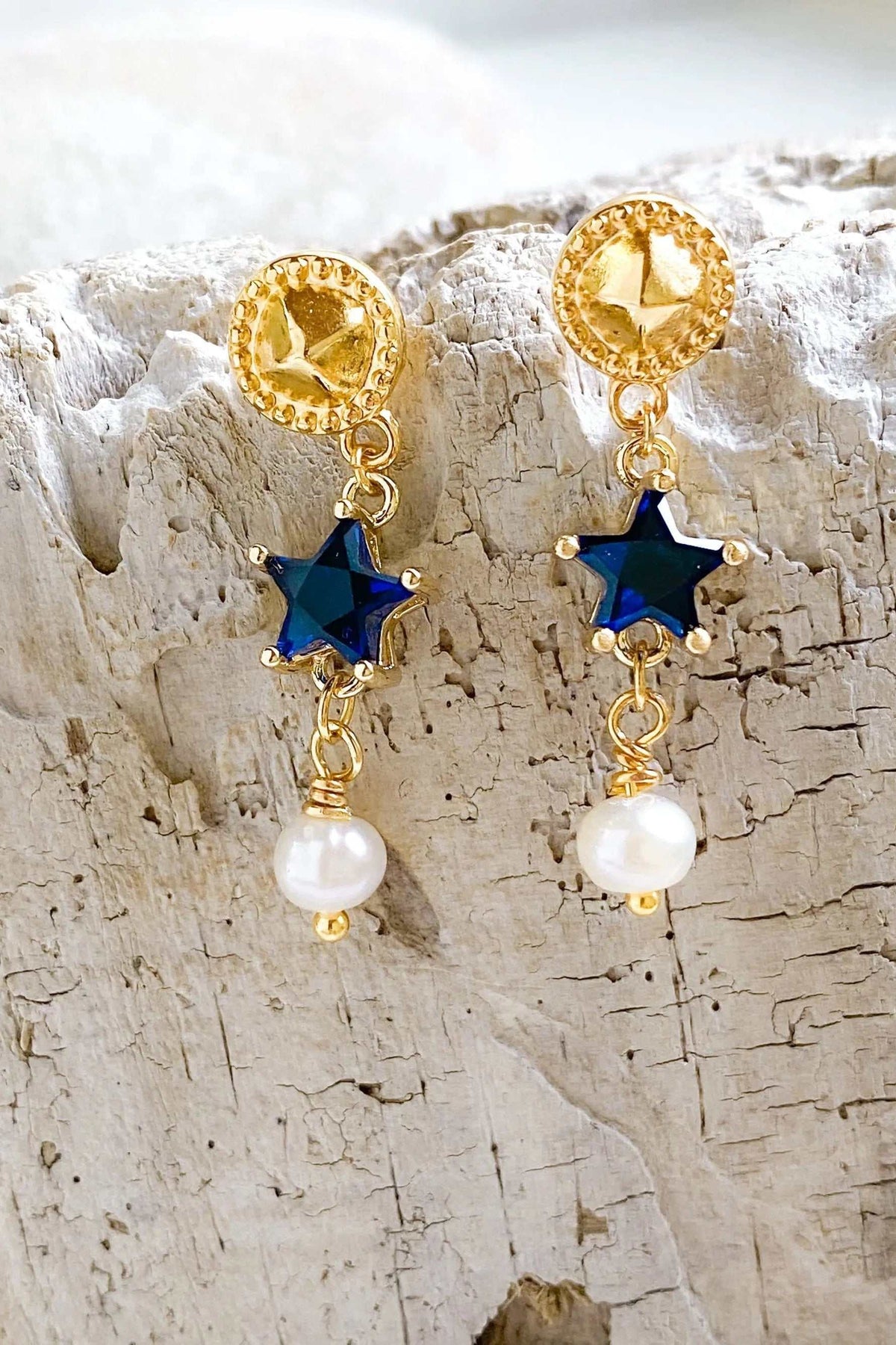 STAR dangle drop earrings in gold-tone brass with deep blue star-shaped stones, textured round studs and white pearls