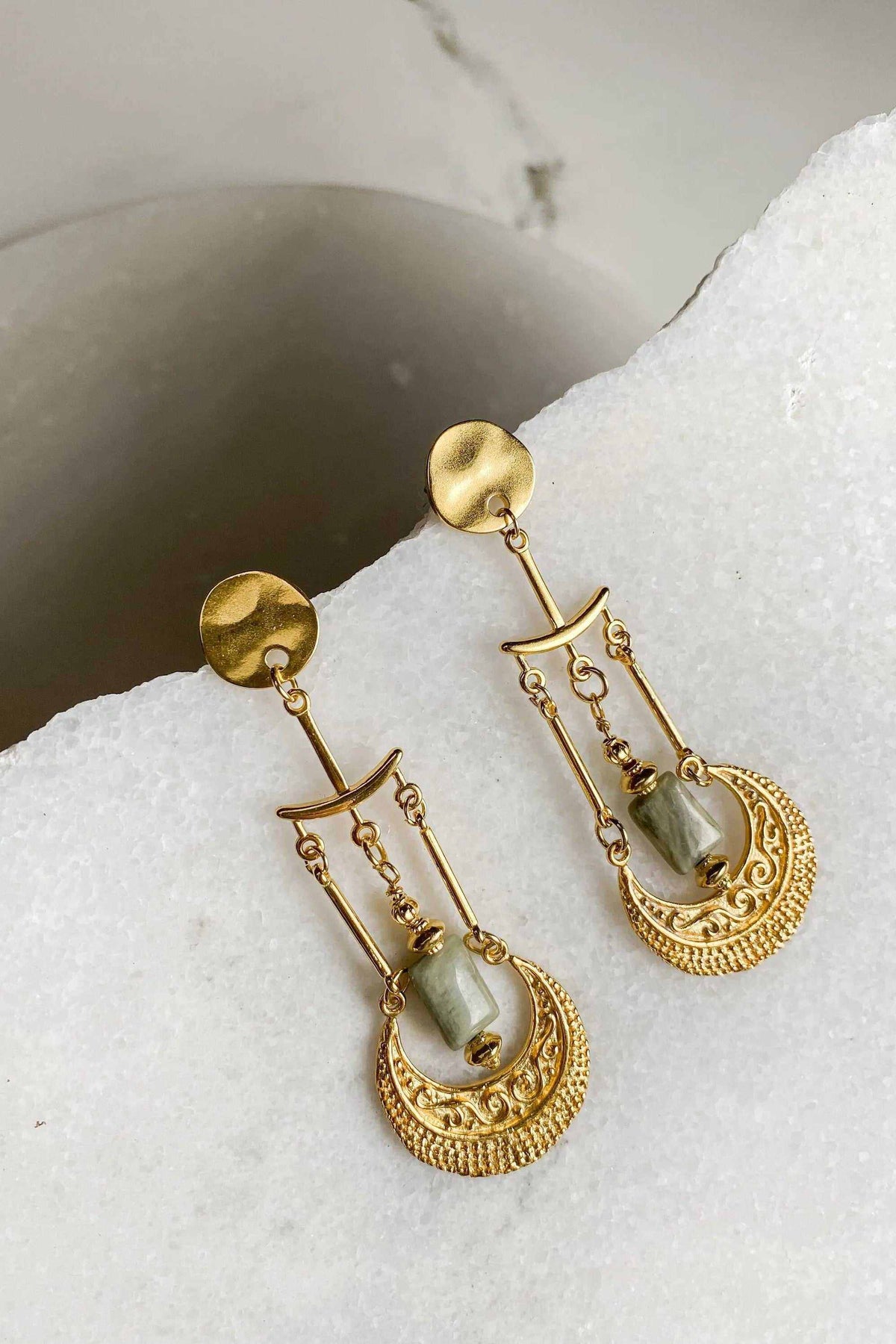 Statement Boho Earrings in gold-tone metal with pale green stones, dangling chains and ornate crescent-shaped drops