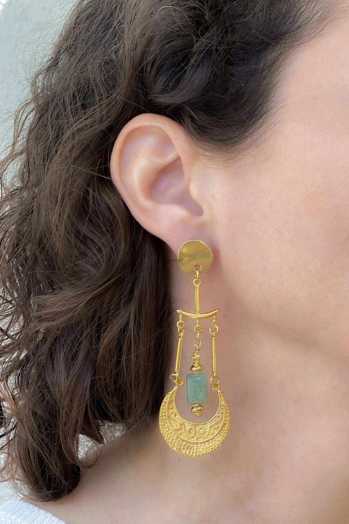 Statement Boho Earrings in gold-tone metal with a green rectangular stone and ornate dangling crescent design