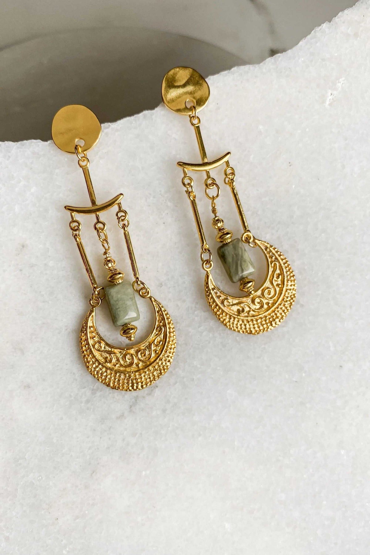 Statement Boho Earrings in gold-tone metal with elongated links, textured oval drops, and green stone accents