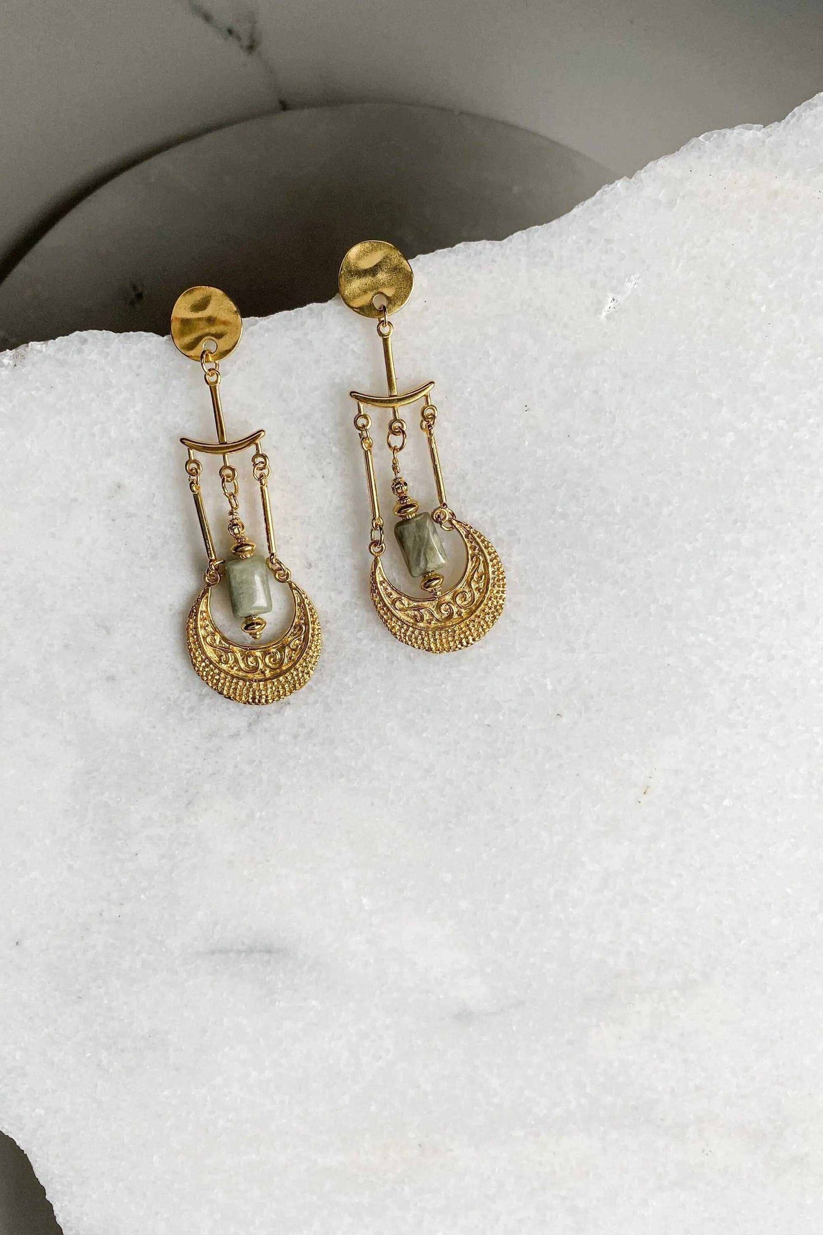 Statement Boho Earrings in gold-tone metal with pale green stones, featuring ornate dangling chains and engraved fan-shaped drops