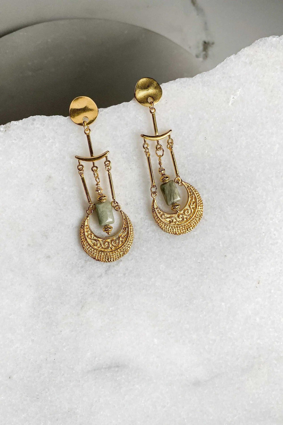 Statement Boho Earrings in gold-tone metal with pale green stones, ornate dangling medallions and delicate chain details