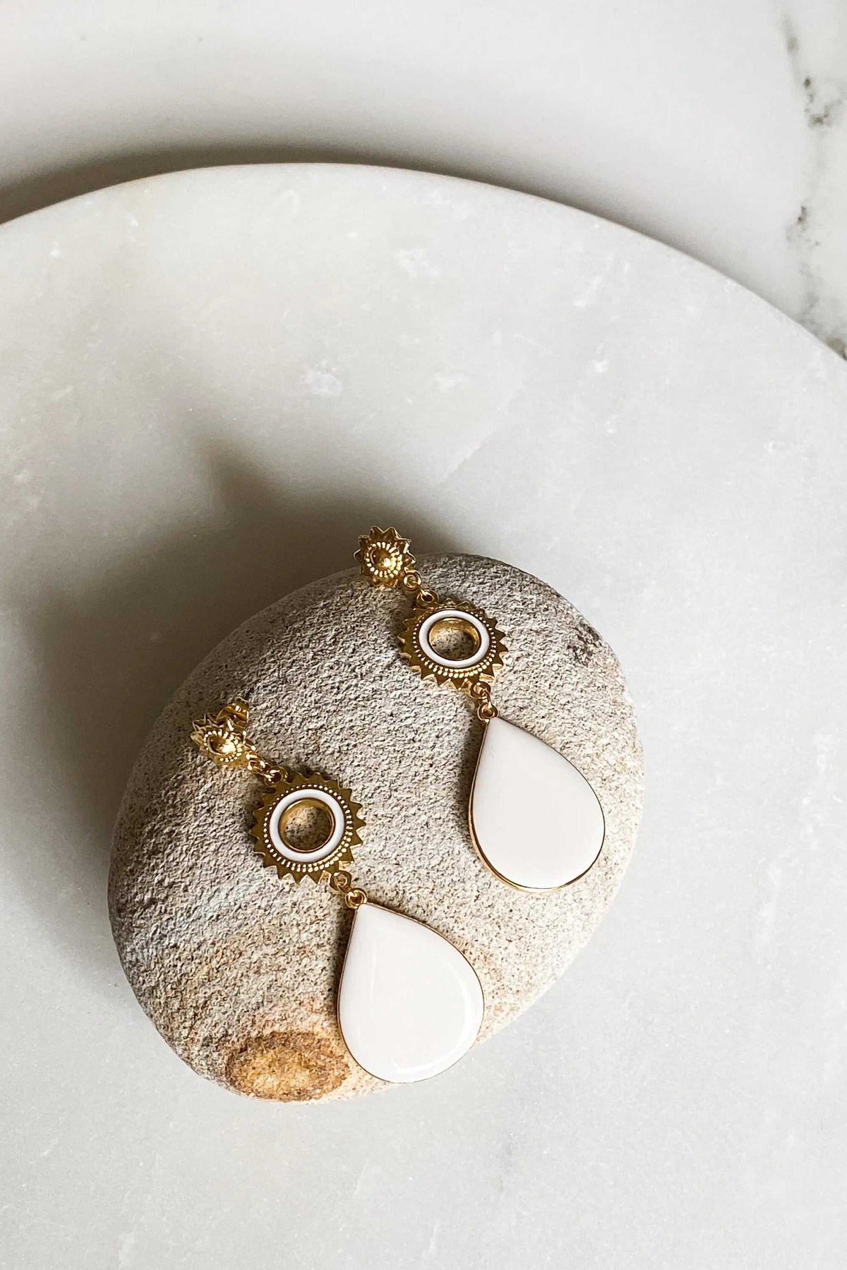 Statement Boho Earrings with gold-tone sunburst studs, textured metal hoops and white teardrop enamel drops