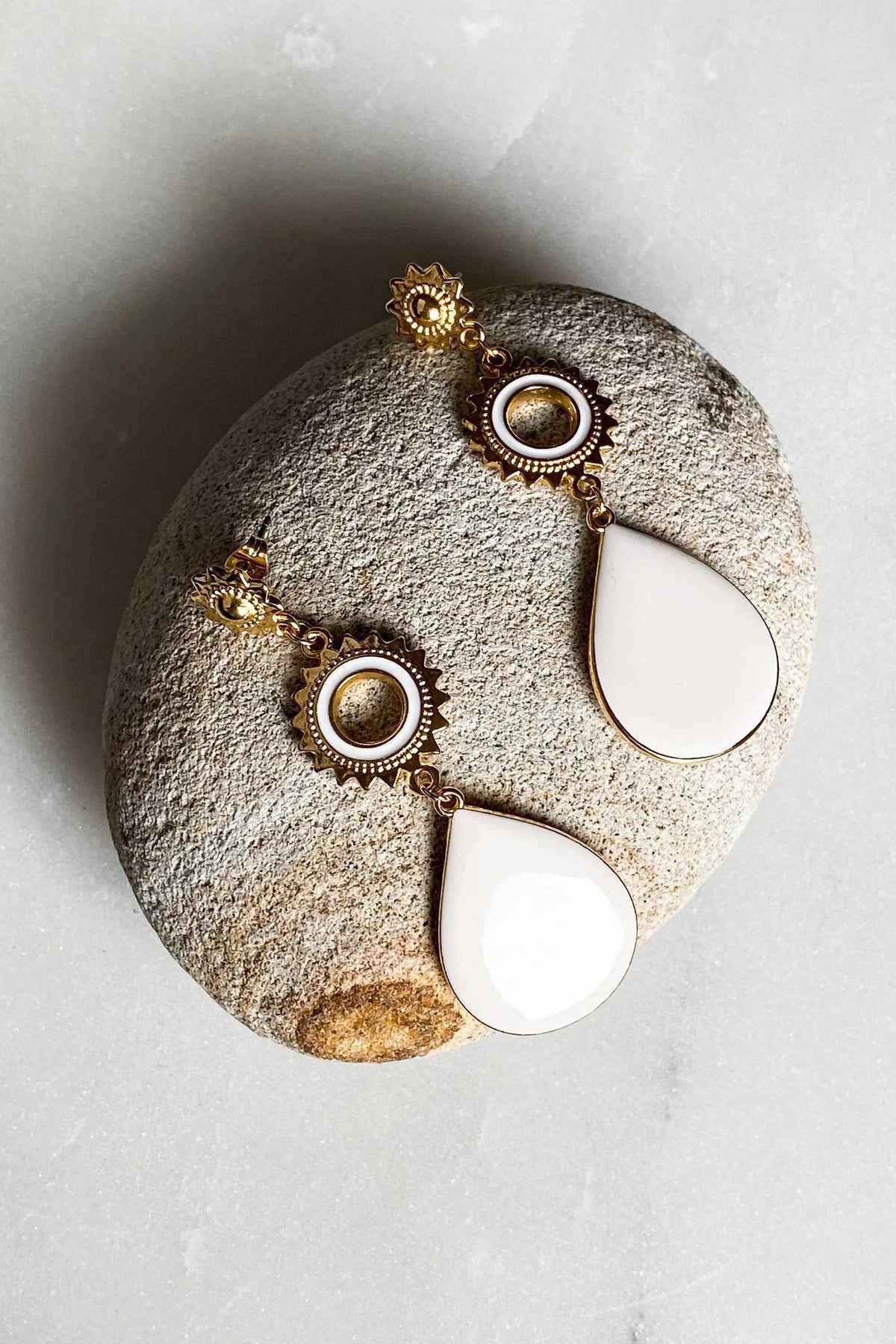 Statement Boho Earrings with gold-toned sunburst studs, circular white enamel accents and large teardrop pendants