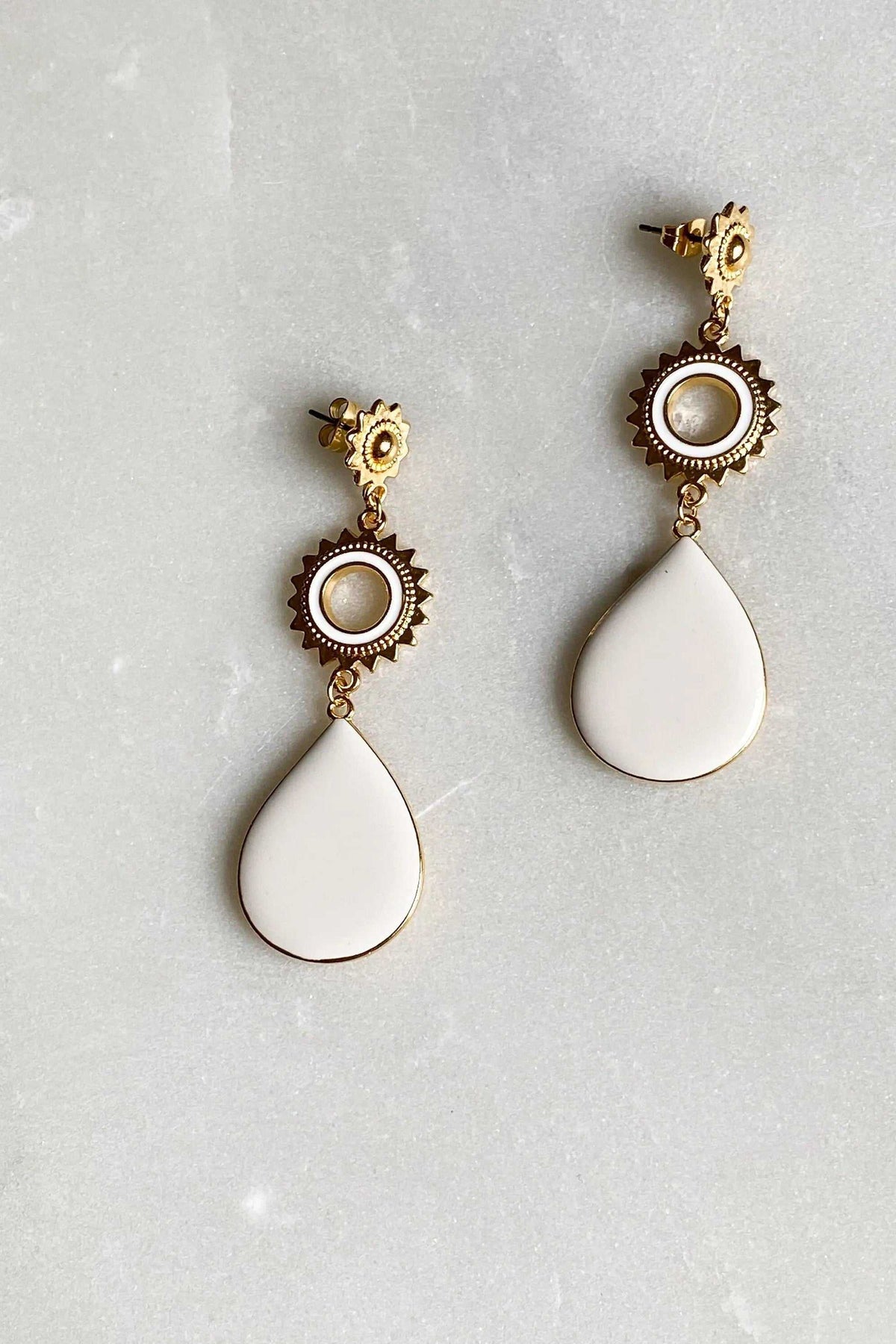 Statement Boho Earrings with gold-tone sunburst medallions and smooth white teardrop pendants in a dangling design