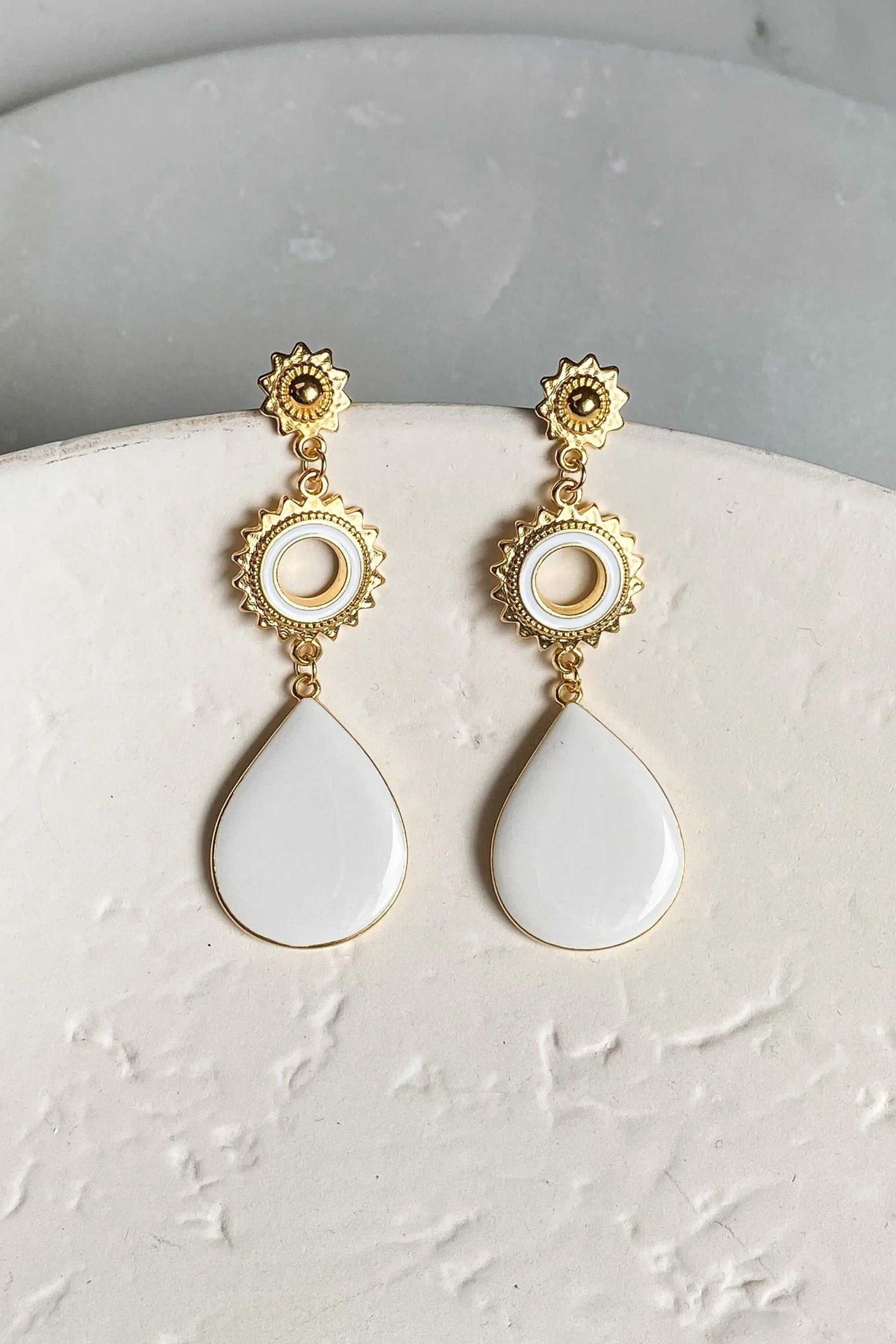Statement Boho Earrings in gold-tone metal with ornate sunburst studs, circular pearl-like centers and white teardrop drops