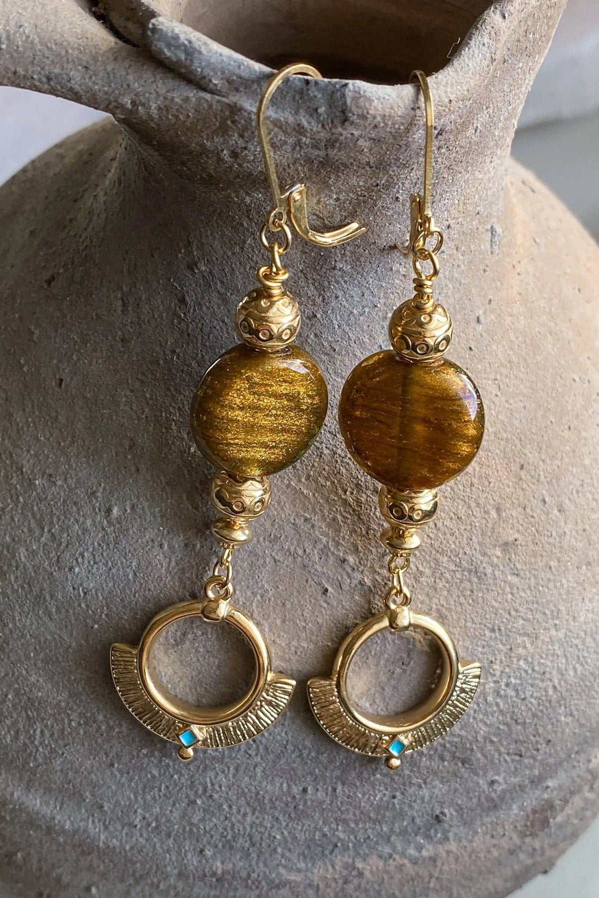 Statement Crystal Earrings with amber-brown round beads, ornate gold-tone metal details and small turquoise accents