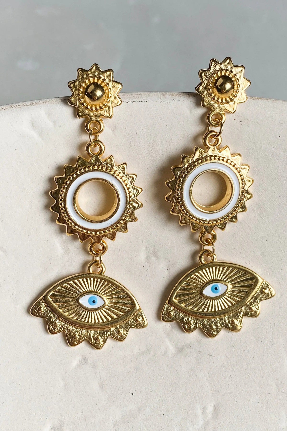 Statement evil eye earrings in gold-tone metal with sunburst studs, circular accents and blue-and-white eye charms