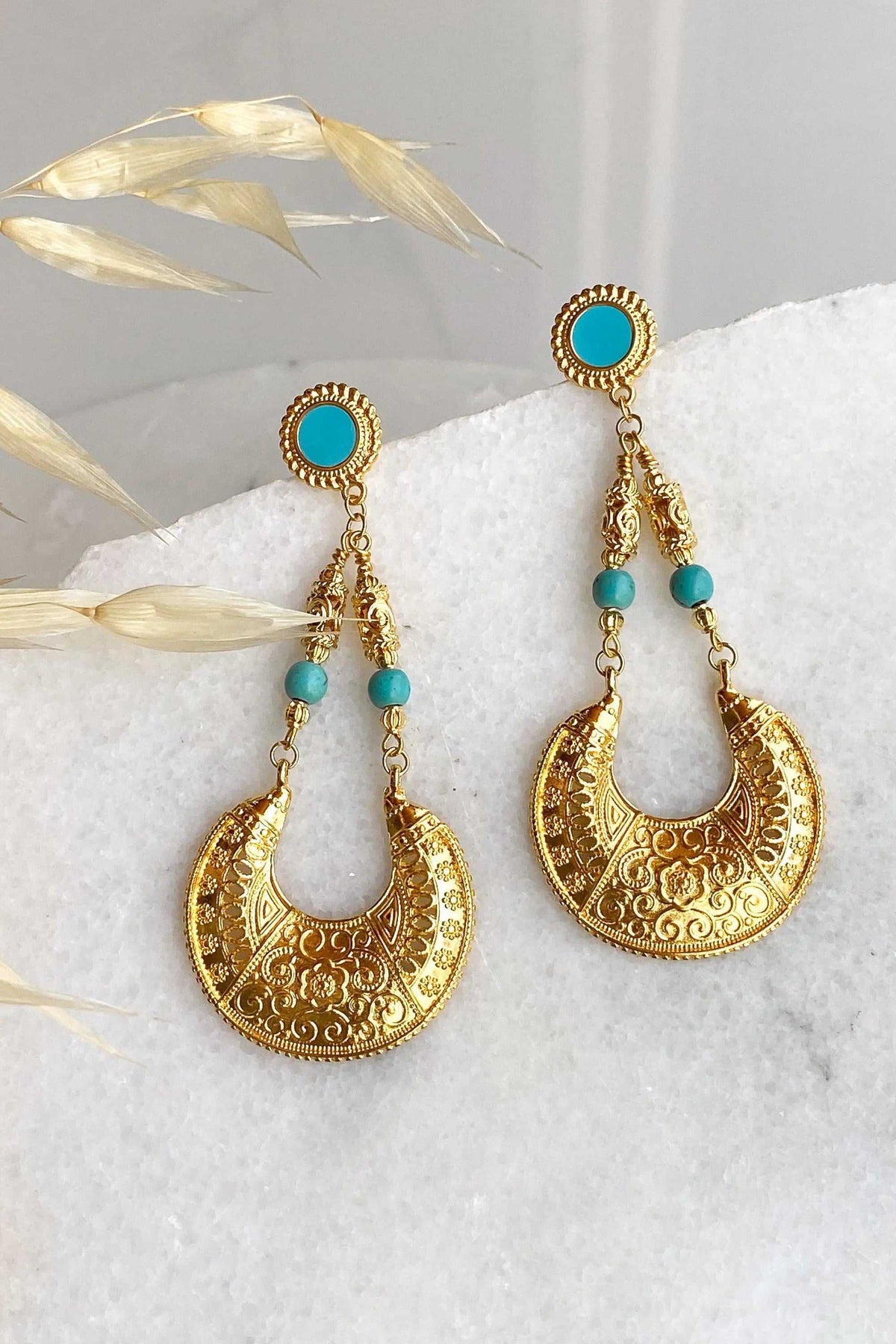 Statement oversize earrings in gold-toned metal with turquoise beads and ornate filigree drop design