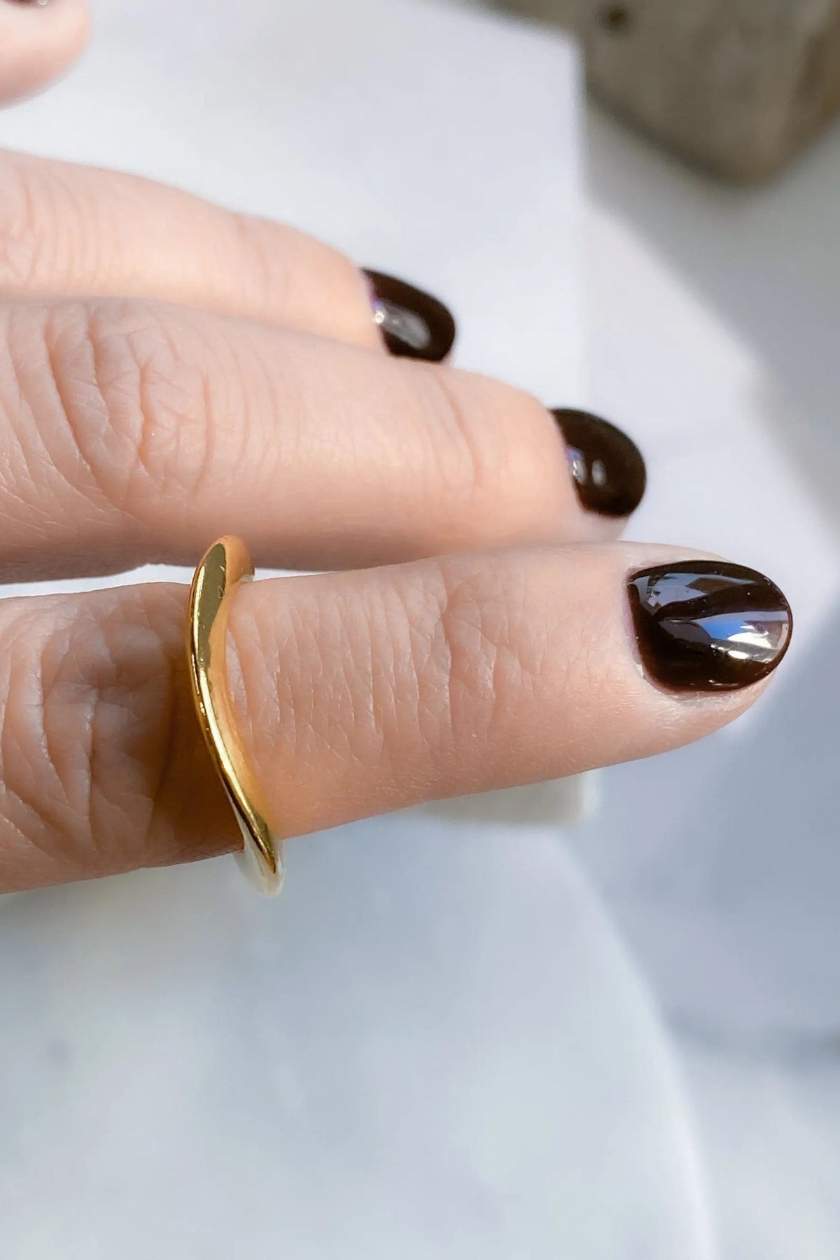 Thick Gold Band ring in polished gold-tone metal, shown as a smooth, slim curved band worn on a finger