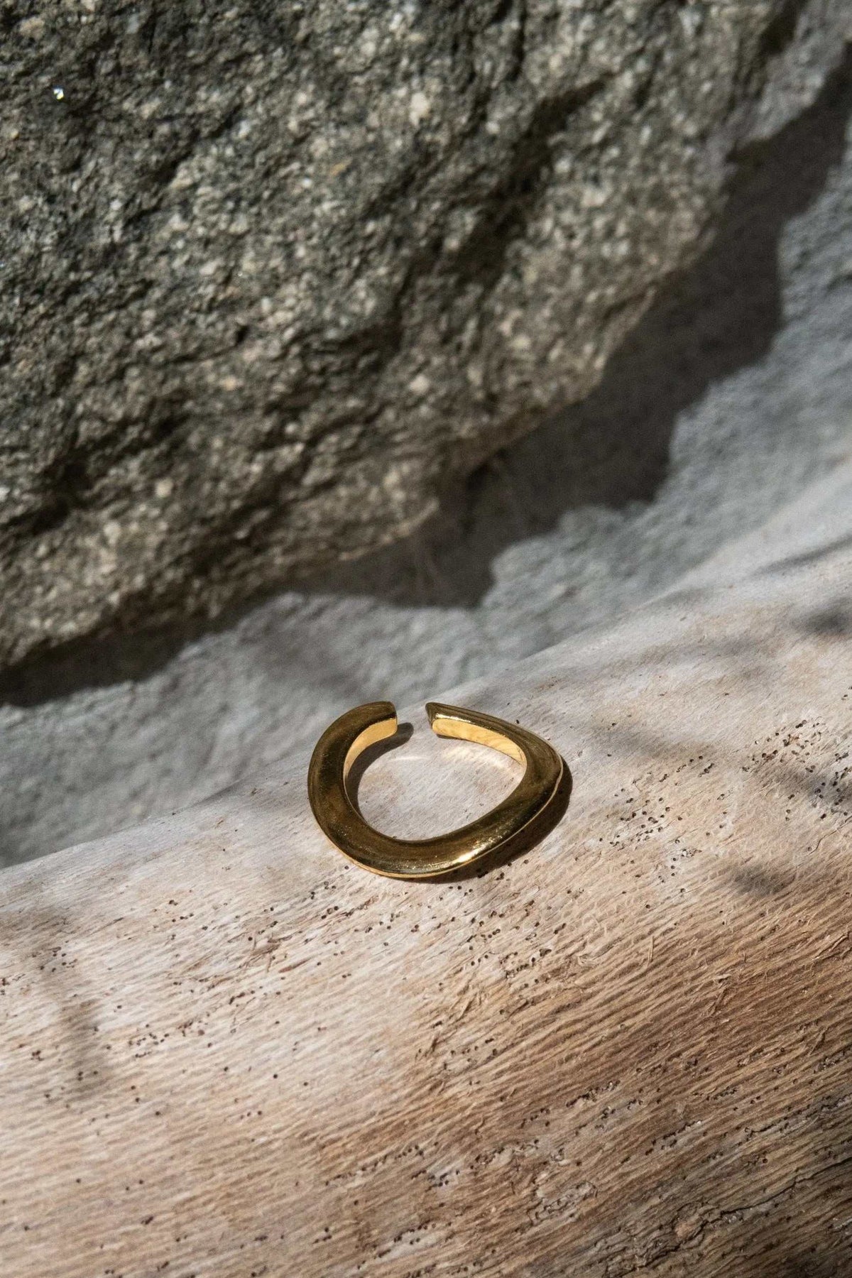 Thick Gold Band ring in polished gold-tone metal, with a broad rounded profile and open adjustable ends