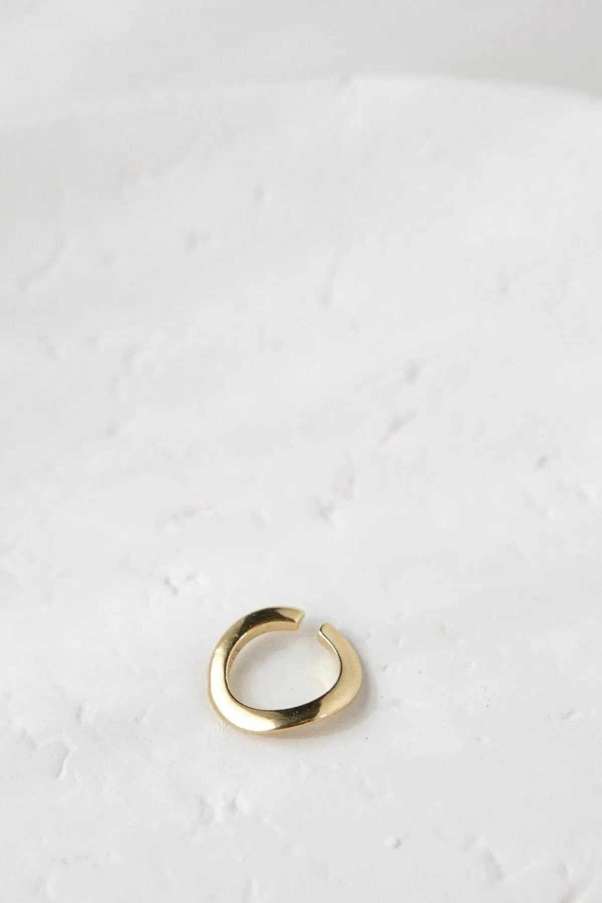 Thick Gold Band ring in polished gold-tone metal, with a wide, smooth open band and slightly adjustable ends