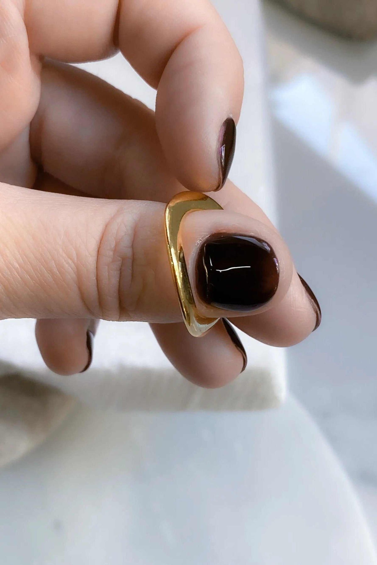 Thick Gold Band ring with a polished gold-tone finish, wide solid band, and gently angular contour