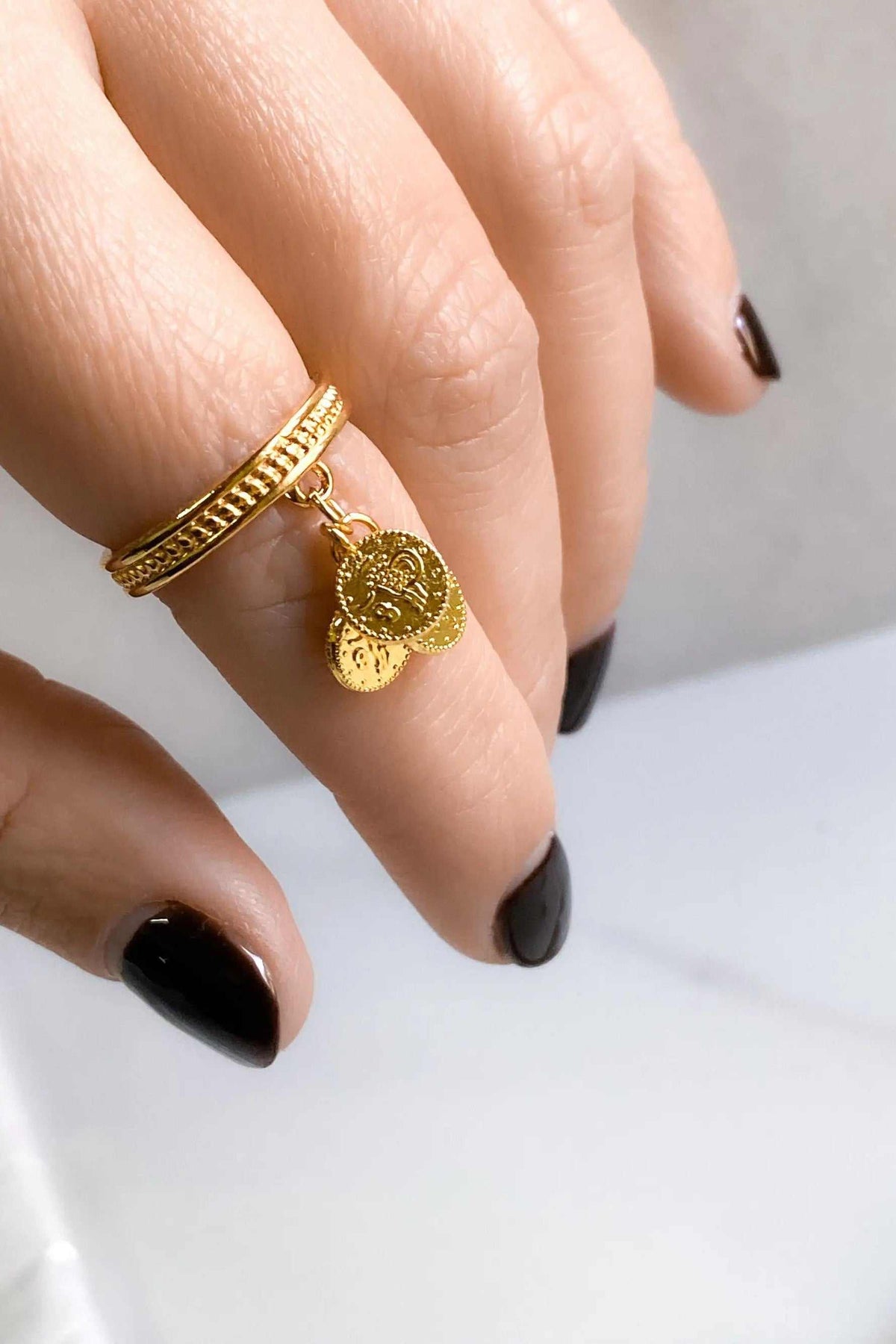 tiny coins ring in gold-tone metal with a textured braided band and two dangling embossed coin charms