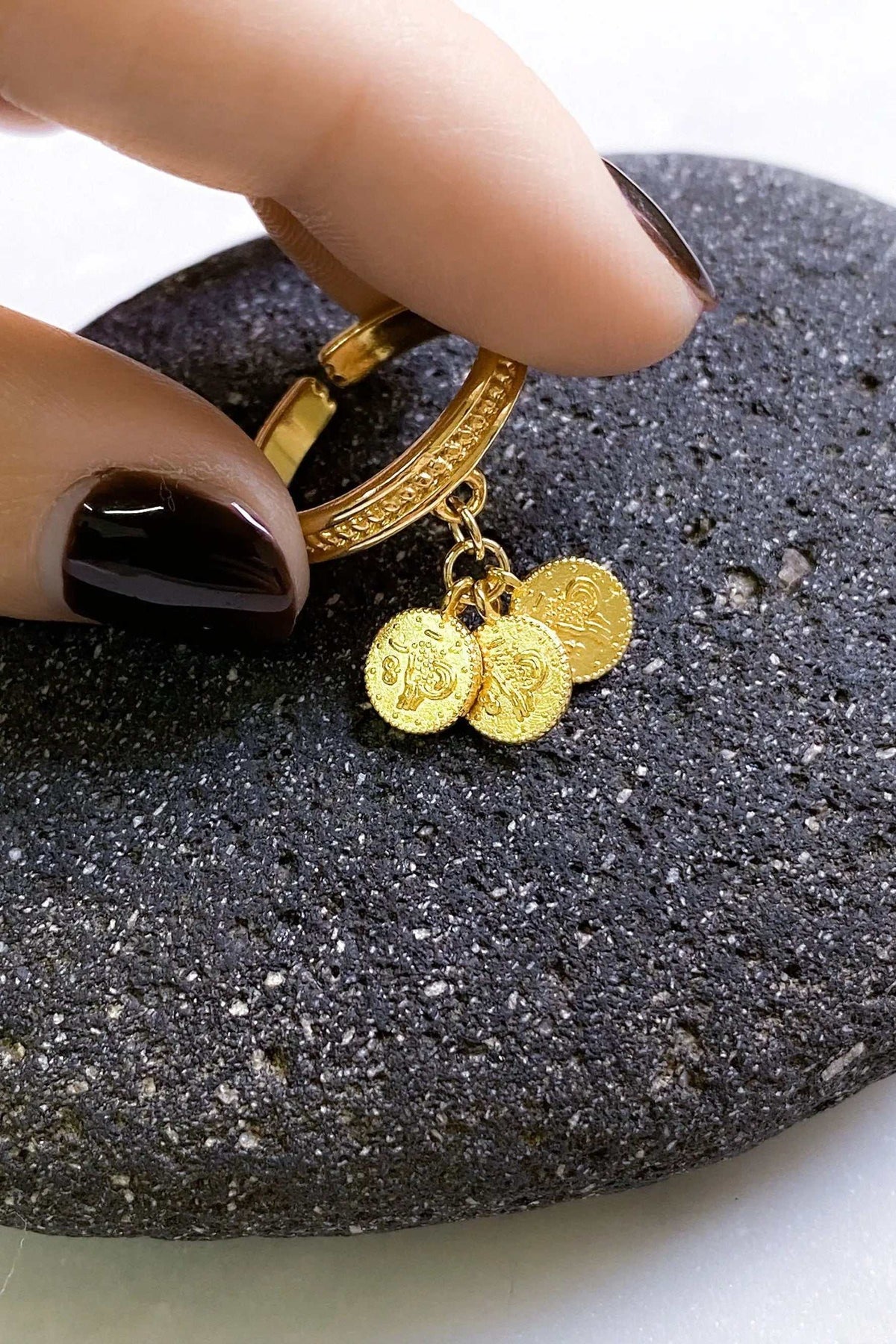 tiny coins ring in gold-tone metal, with an engraved band and three dangling round coin charms