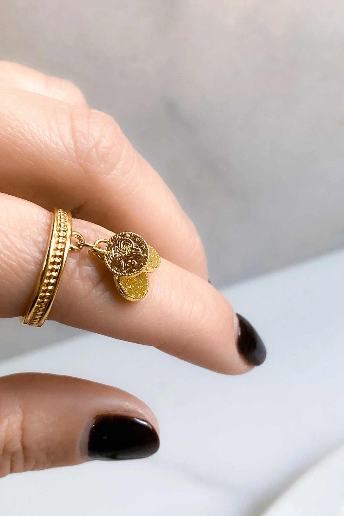 tiny coins ring in gold-tone metal with two textured coin charms and a slim ridged adjustable band