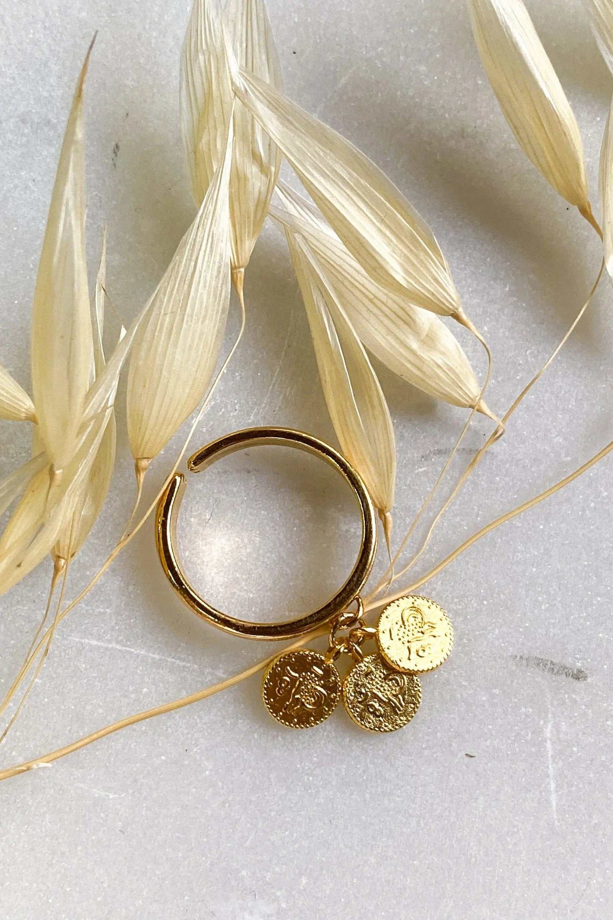 tiny coins ring in gold-tone metal with three small textured coin charms dangling from an adjustable band