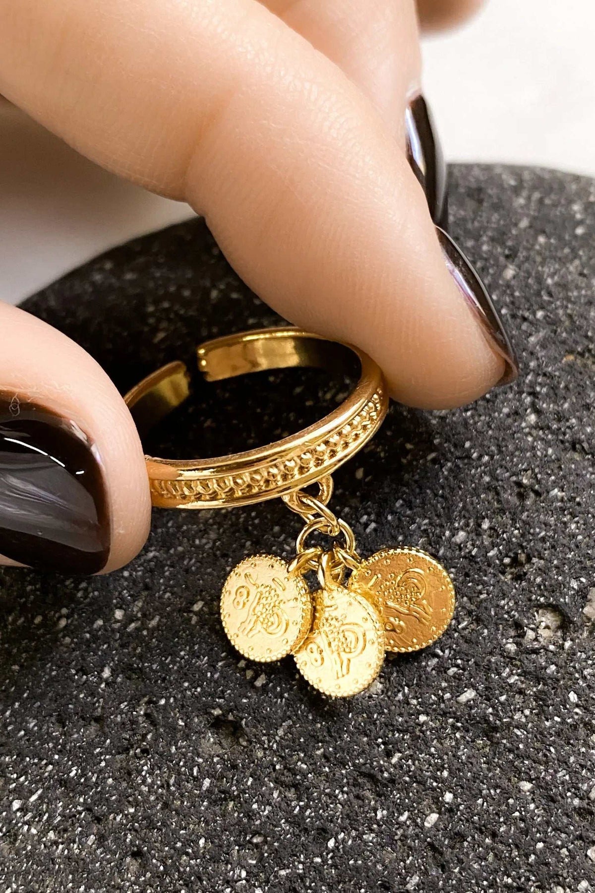 tiny coins ring in gold-tone metal, featuring a textured band and three dangling embossed coin charms