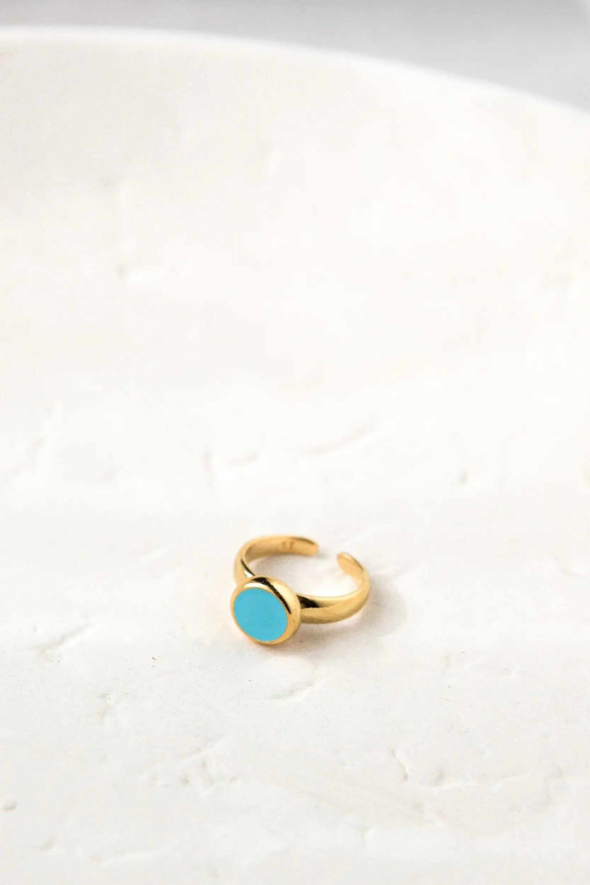 Turquoise Womens ring in gold tone with a smooth round turquoise-colored face and adjustable open band