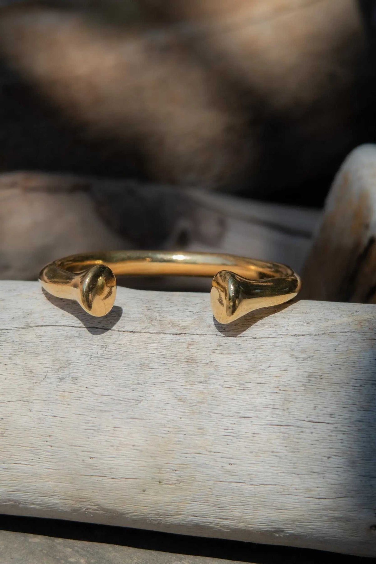 URGO Gold Bracelet, shiny gold-tone open bangle with a smooth rounded band and sculpted tapered ends