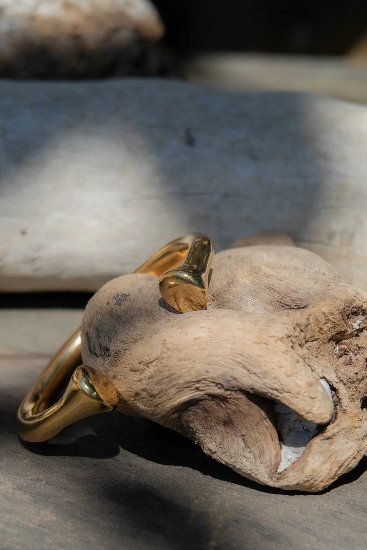 URGO Gold Bracelet, thick polished gold-tone bangle with a smooth curved band and bold sculptural form