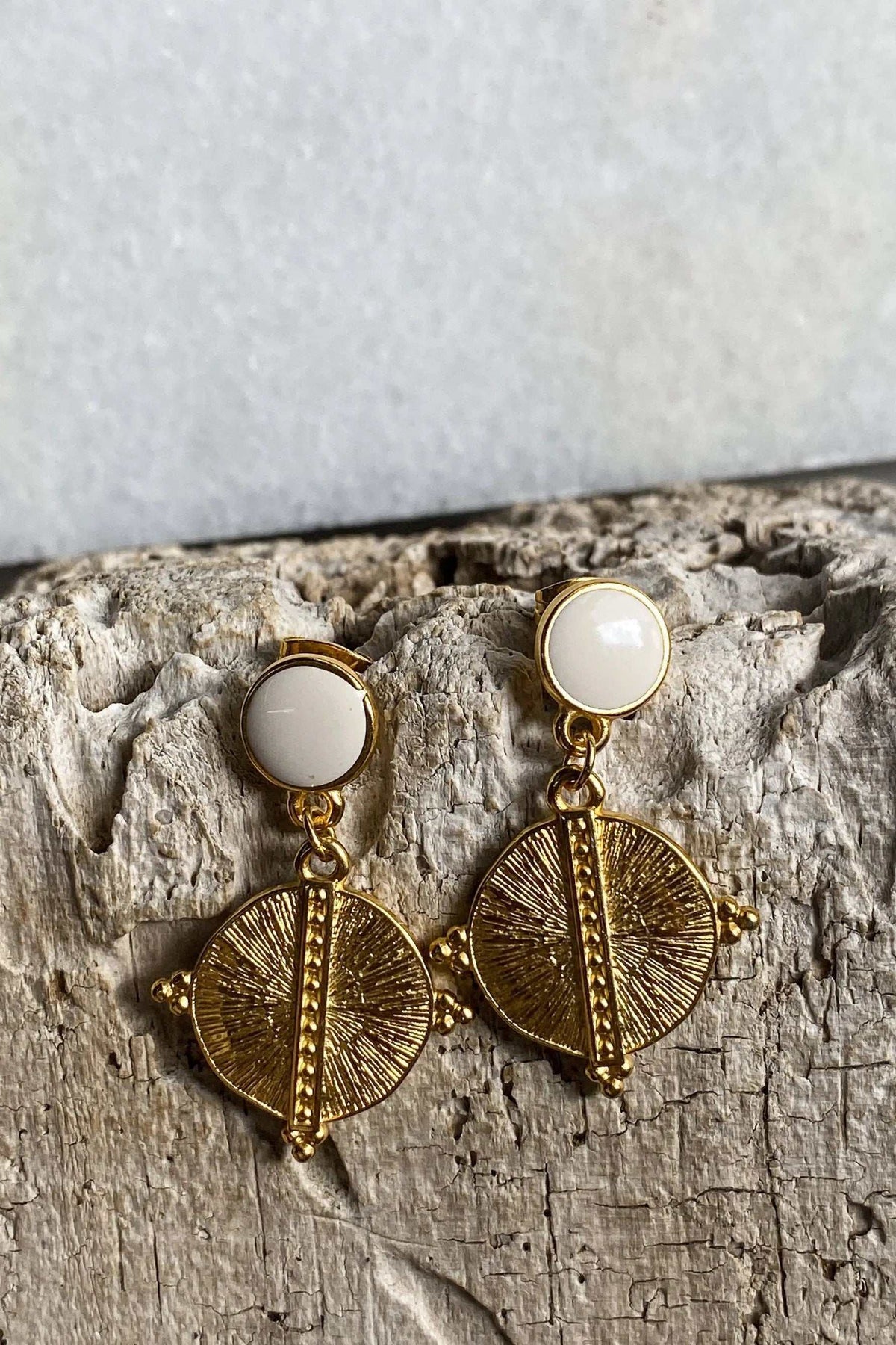 White Gold Boho earrings with gold-tone circular sunburst pendants and round white resin studs