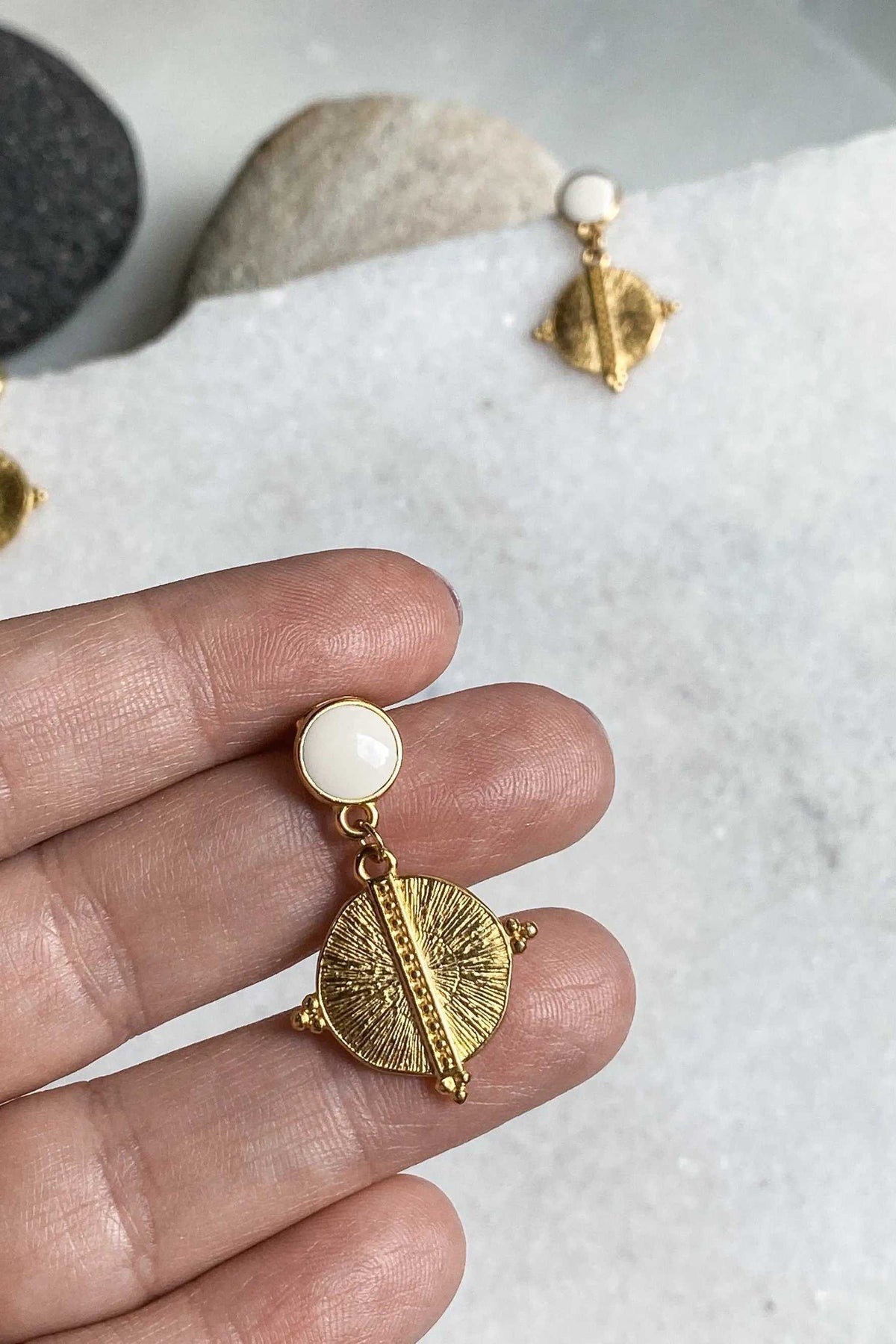 White Gold Boho earrings with a white round stud and gold-tone textured circular drop with raised center bar