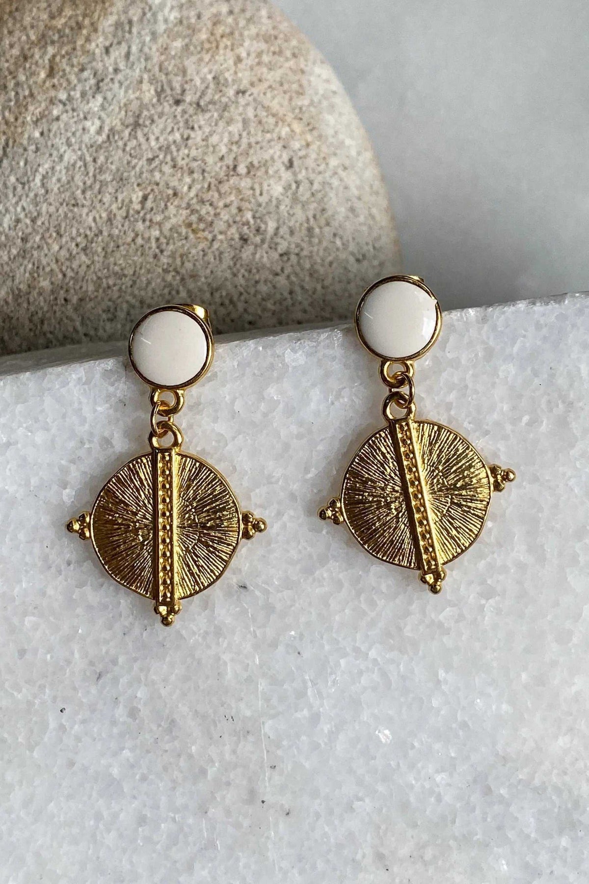 White Gold Boho earrings with white round studs and gold-tone dangling sunburst discs featuring raised central bars