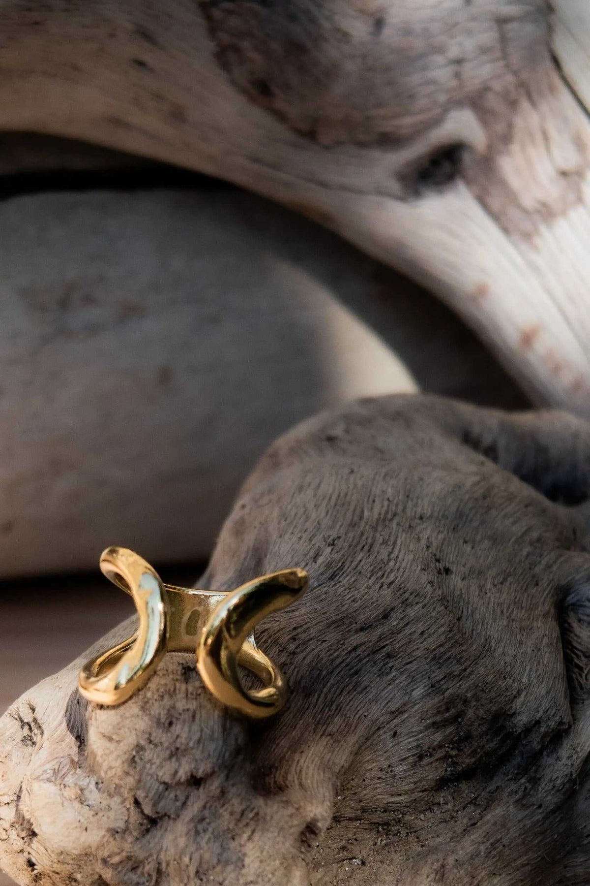 Wide Organic RING in gold-tone metal with a broad sculptural design and curved, open ends