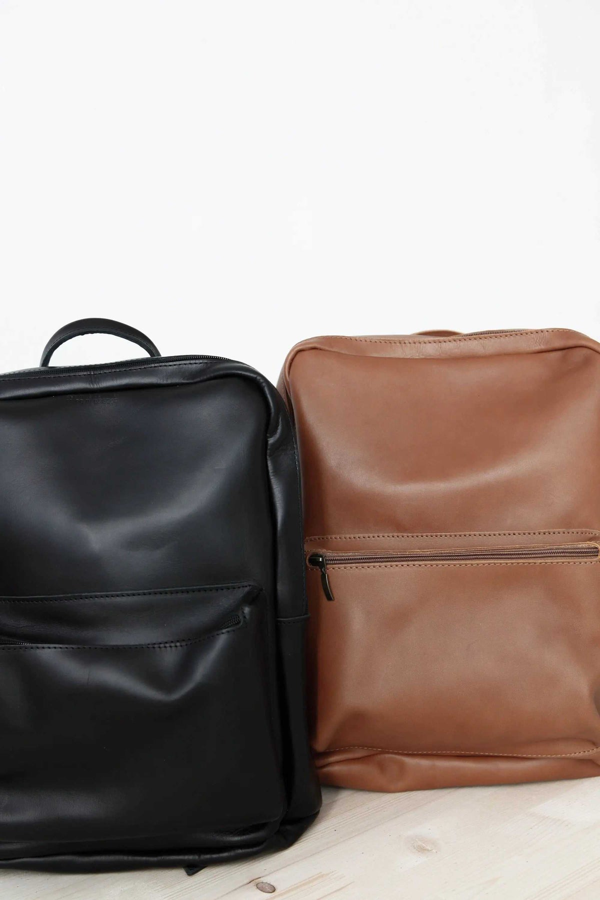 XLARGE BACKPACK leather rucksacks in black and camel with top handles and front zip pockets