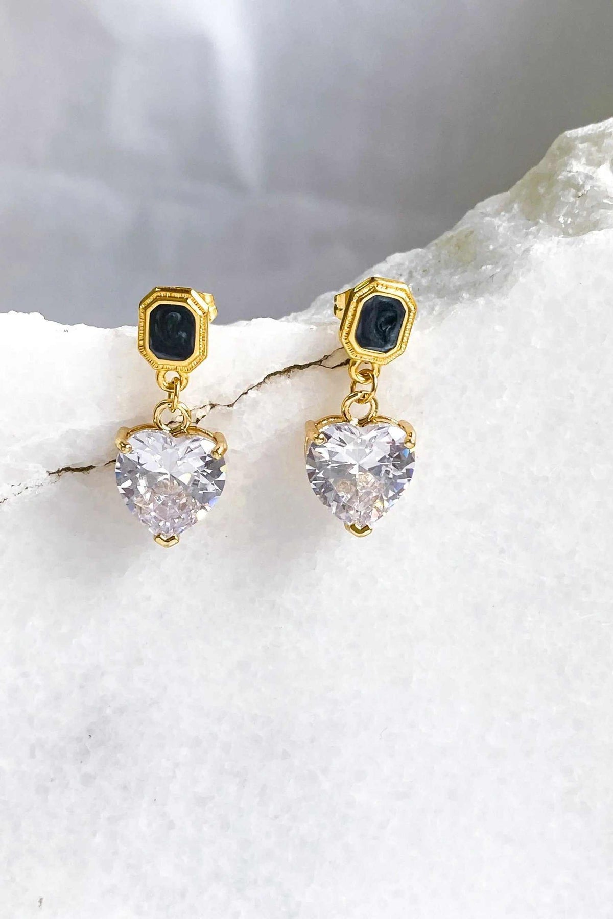 Zircon Heart Earrings with clear faceted heart drops, gold-tone settings and black rectangular stud accents