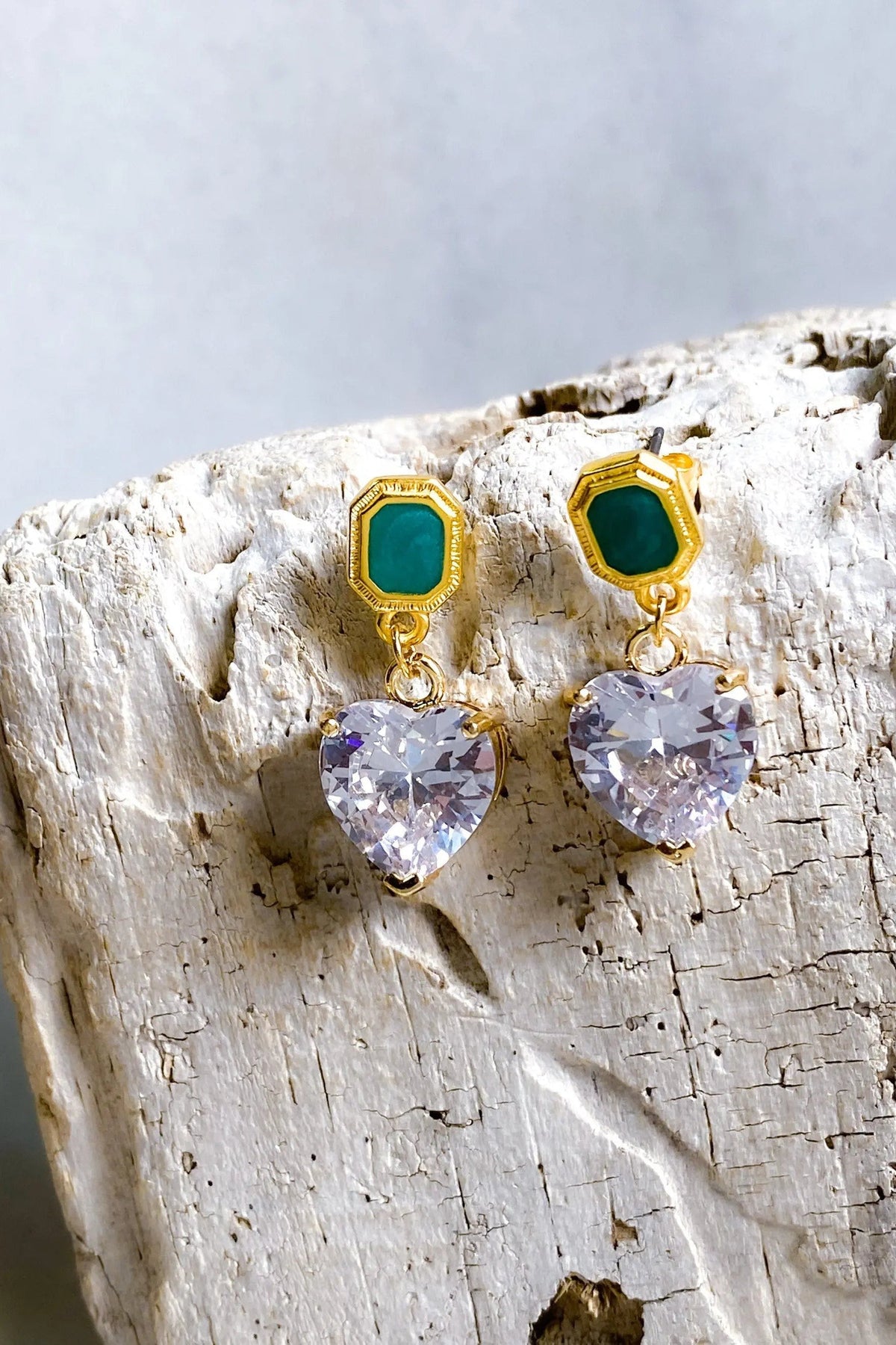 Zircon Heart Earrings with clear faceted heart-shaped stones, green rectangular studs, and gold-tone settings