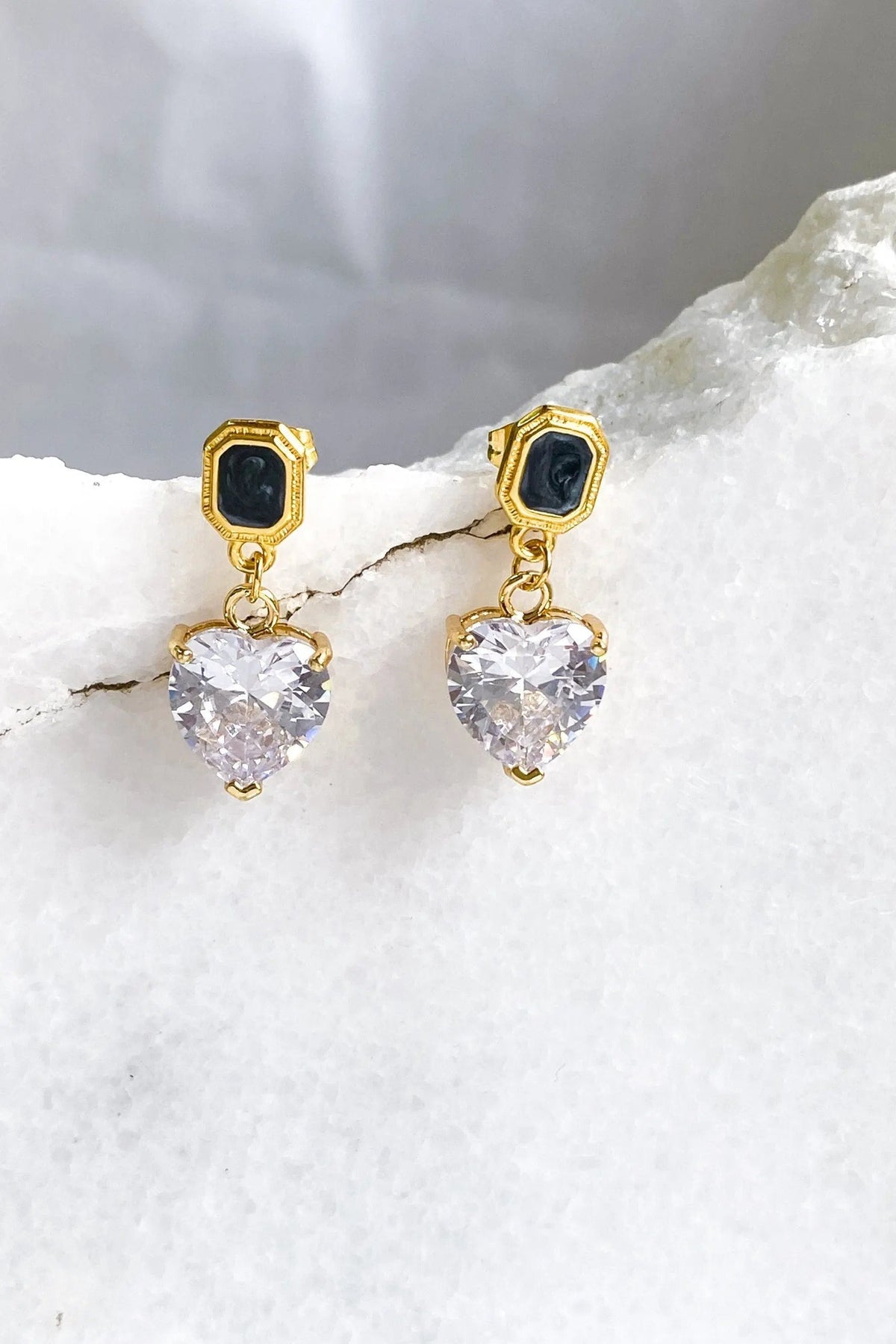Zircon Heart Earrings with gold-tone geometric studs, black insets, and dangling clear faceted heart-shaped stones