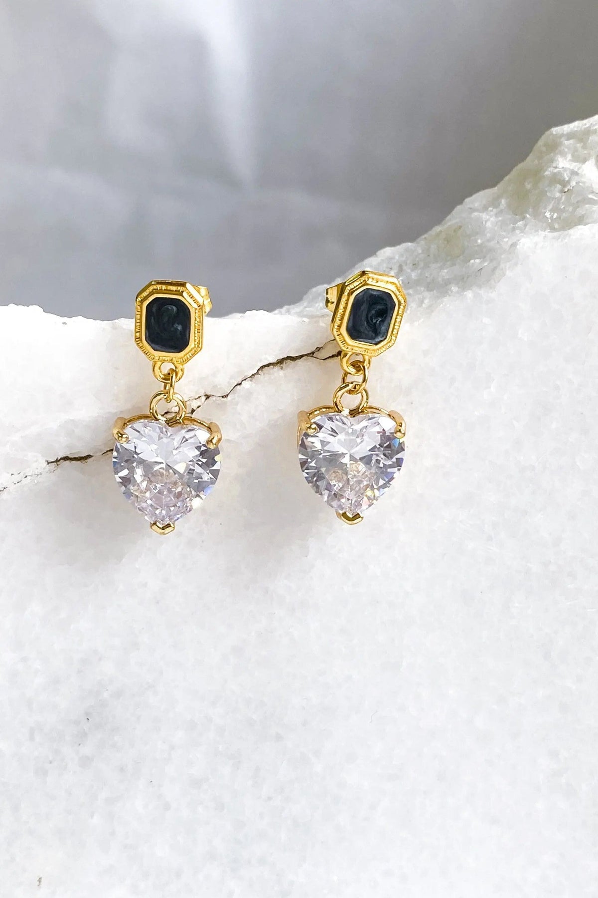 Zircon Heart Earrings with gold-tone geometric studs, black centers, and sparkling clear faceted heart-shaped drops