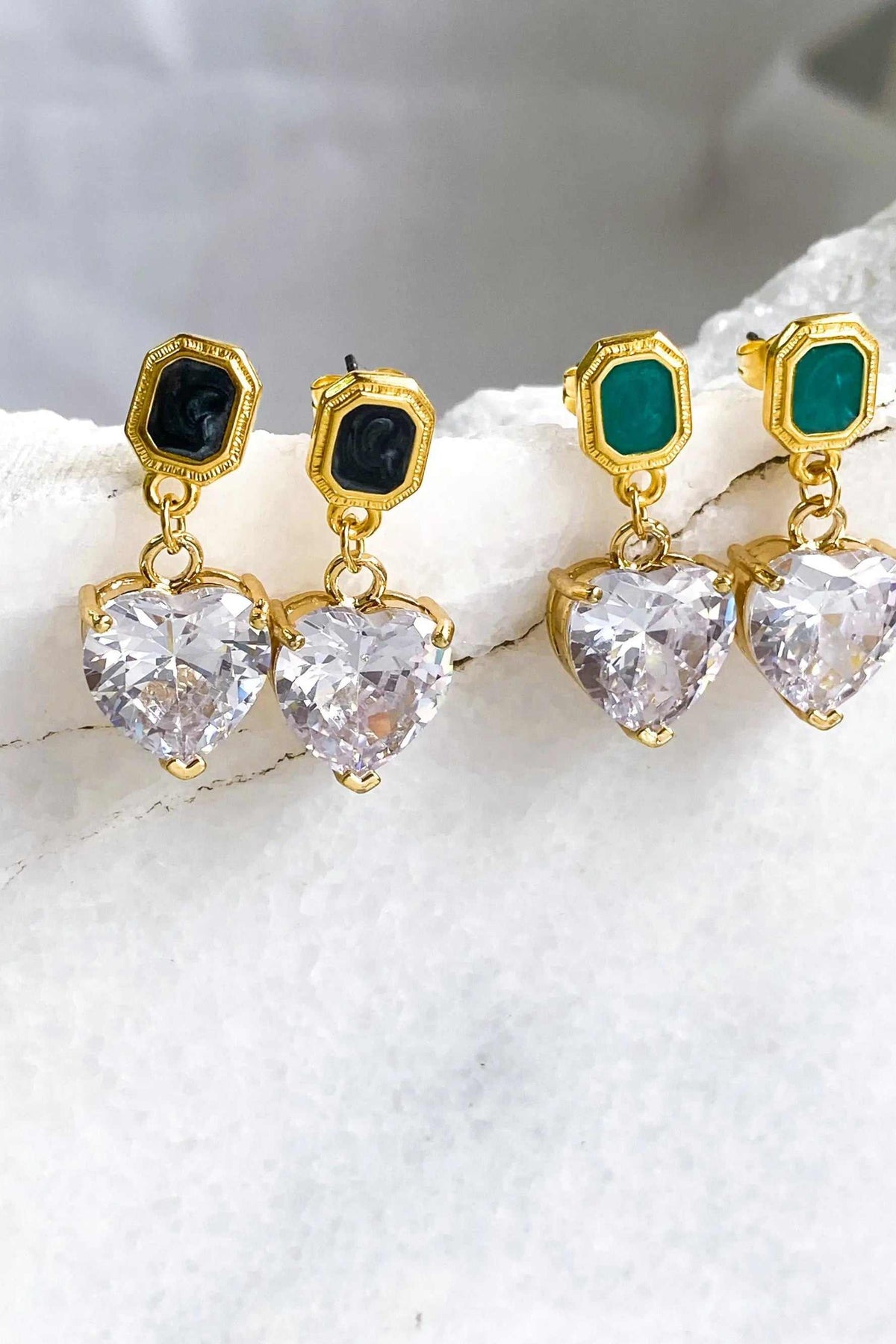 Zircon Heart Earrings with gold-tone settings, black and green rectangular studs, and large clear heart-shaped stones