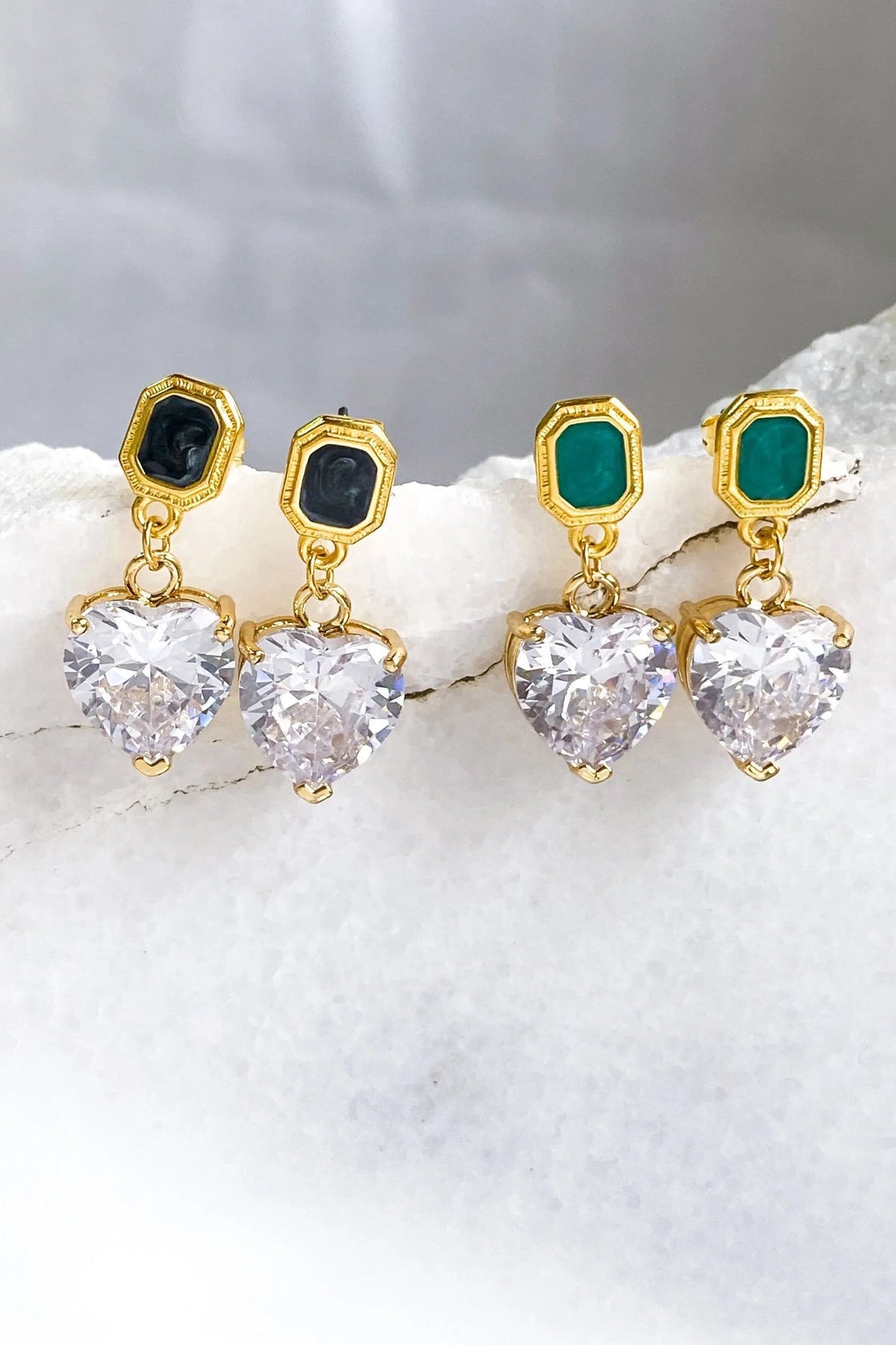 Zircon Heart Earrings with gold-tone geometric studs, black and teal stones, and dangling clear heart-shaped gems